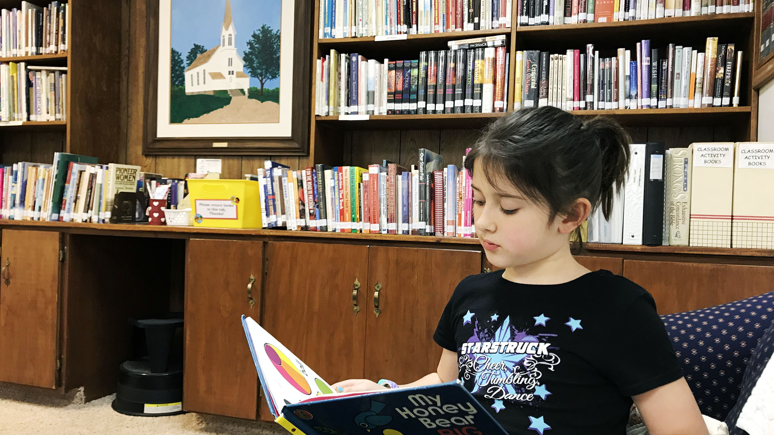 Child reading in church library